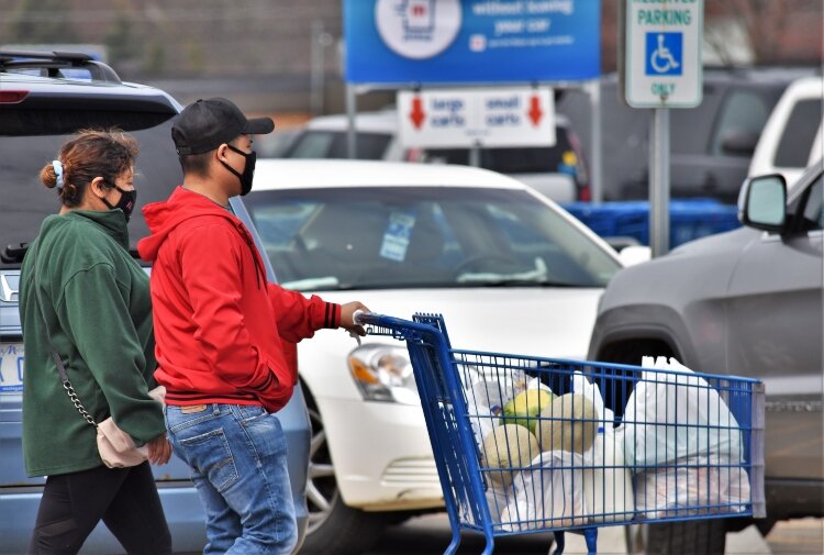 Shoppers at at Meijer on East 16th Street in Holland take protective measures to prevent the spread of the coronavirus.