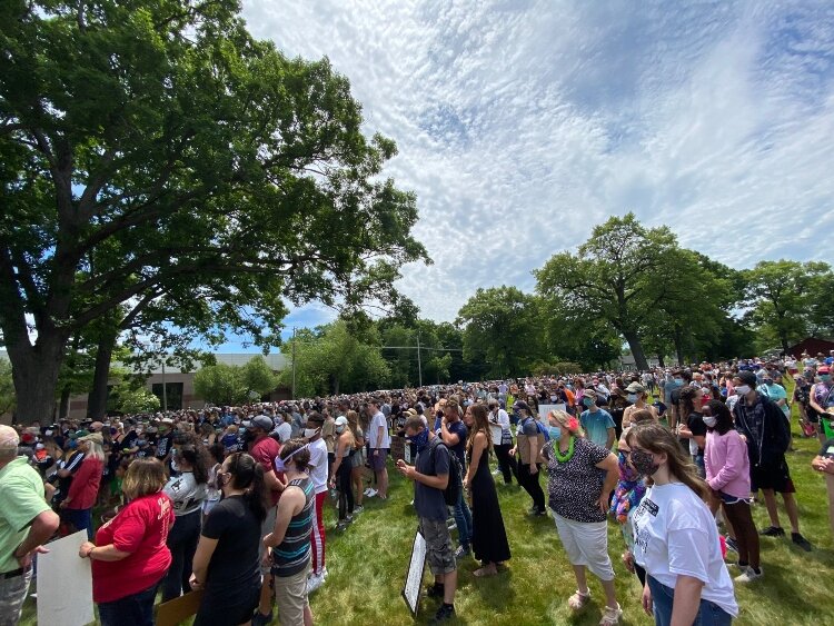 Organizers addressed the crowd that filled the grassy field across the street from Harbor Church, 269 Douglas Ave., before the march began.