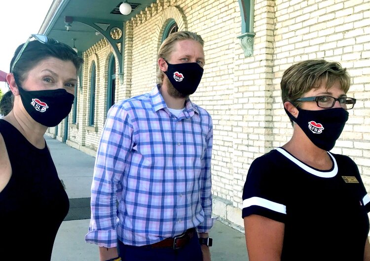 Spring Lake DDA Director Angela Stanford-Butler, Grand Haven Main Street Executive Director Jeremy Swiftney and Ferrysburg Mayor Rebecca Hopp wear their "love of community" masks.