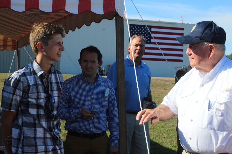 Jake Tebos, (left) wholesale grower of potting plants in Allendale, discusses issues unique to his niche in the marketplace with Secretary Perdue (right). 