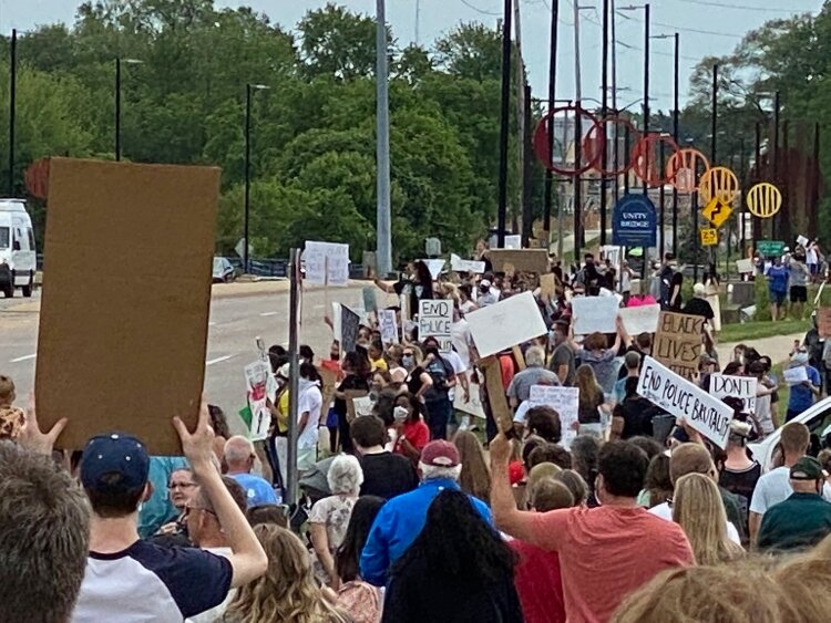 Chants of “No justice! No peace!” and “Black Lives Matter” were punctuated by enthusiastic car horns of support as people lined Holland's Unity bridge.