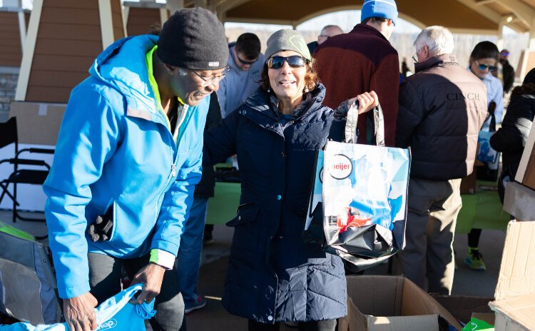 Volunteers working together to check participants in at MOWWM's March for Meals Community Walk and 5k. 