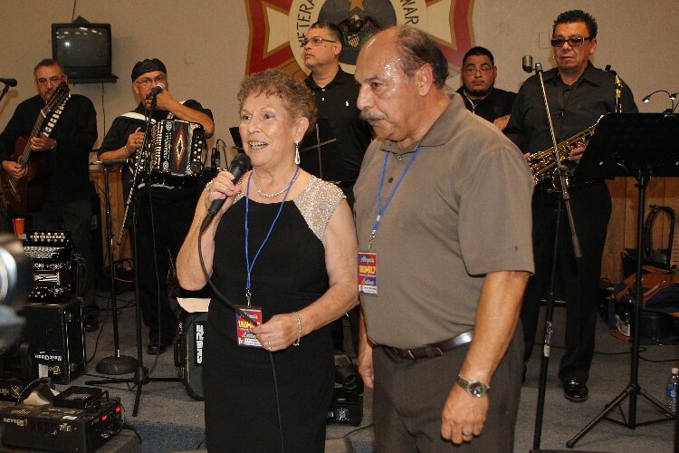  Lupita Reyes and Jesus Martinez introduce Karizma Band during a dance honoring the 50th anniversary of the "Alegria Latina" radio program at the VFW Post 2144 in Holland in 2015. (J.R. Valderas)