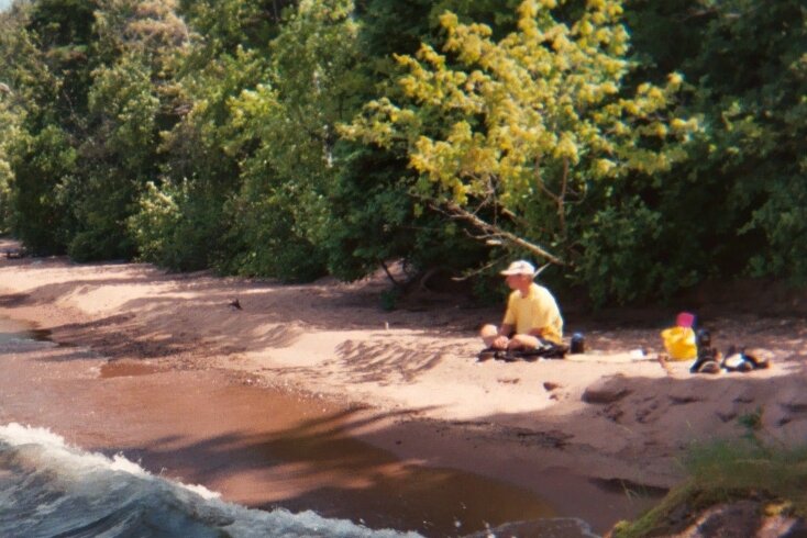 Paul Ecklund is shown sitting on a beach during a camping trip to Wisconsin's Apostle Islands in 1995. (Paul Ecklund)