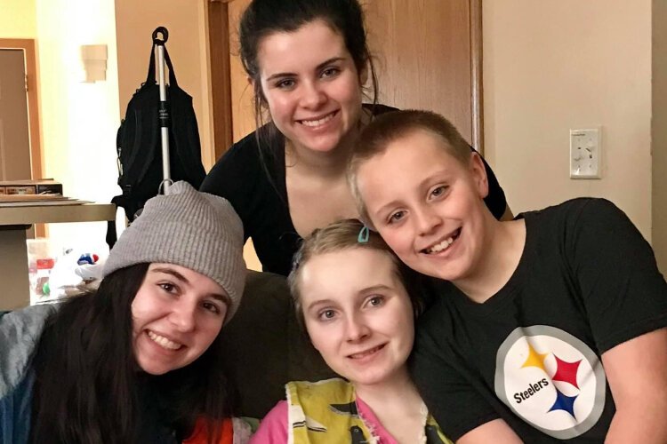 Breanna Lentz, center, was diagnosed with juvenile Huntington's Disease and died before she could attend high school. Her sister, Shelby,  has established a foundation and a scholarship in Breanna's honor.