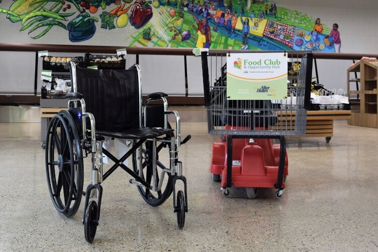 This wheelchair and motorized shopping cart were donated to the newly-opened Food Club & Opportunity Hub for guests to use. (CAH)