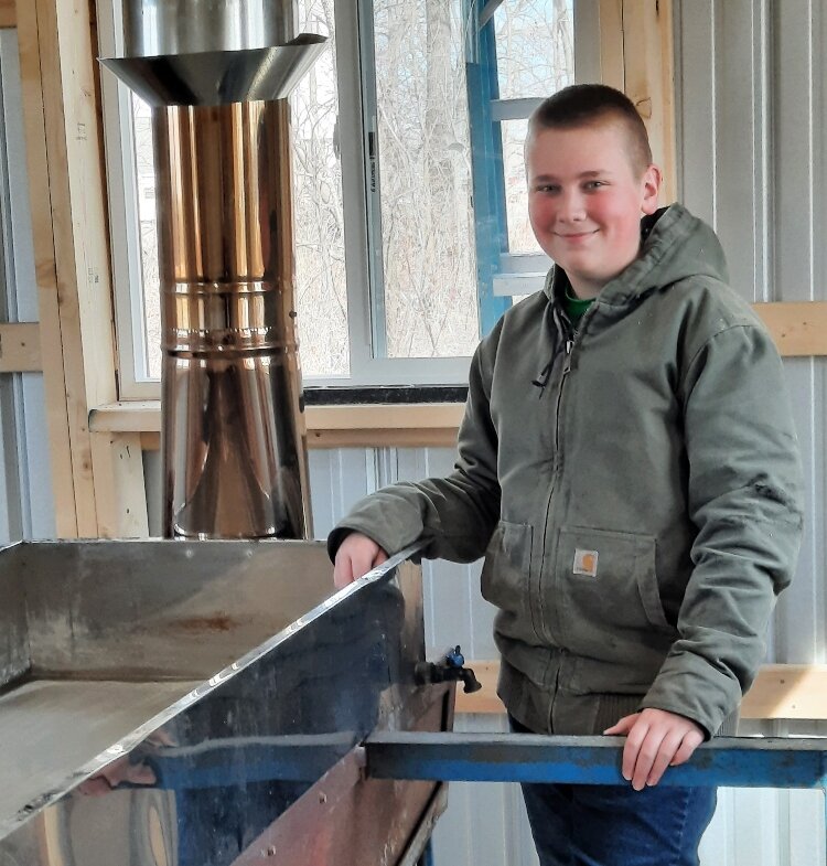 Colby Tucker of Hopkins enjoys collecting sap and making syrup with his Dad, Craig. 