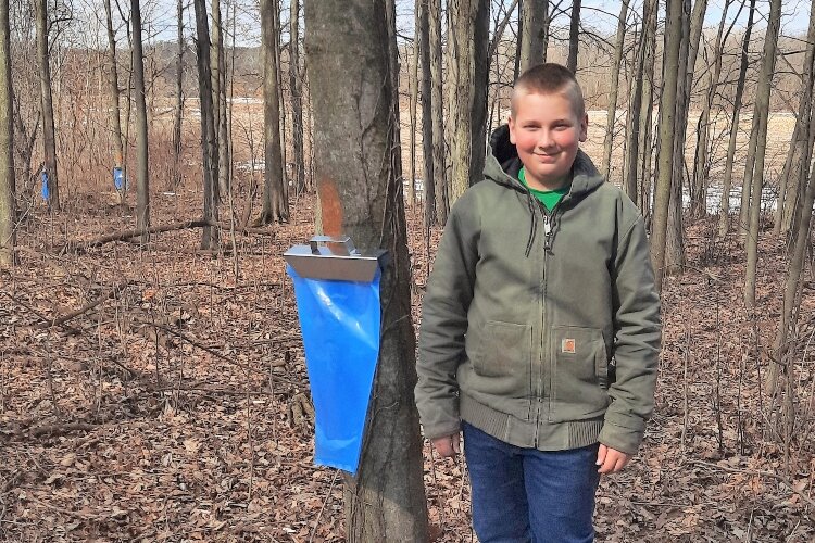 Colby Tucker, 14, from Hopkins in Allegan County, is in his third year of collecting and cooking sap.