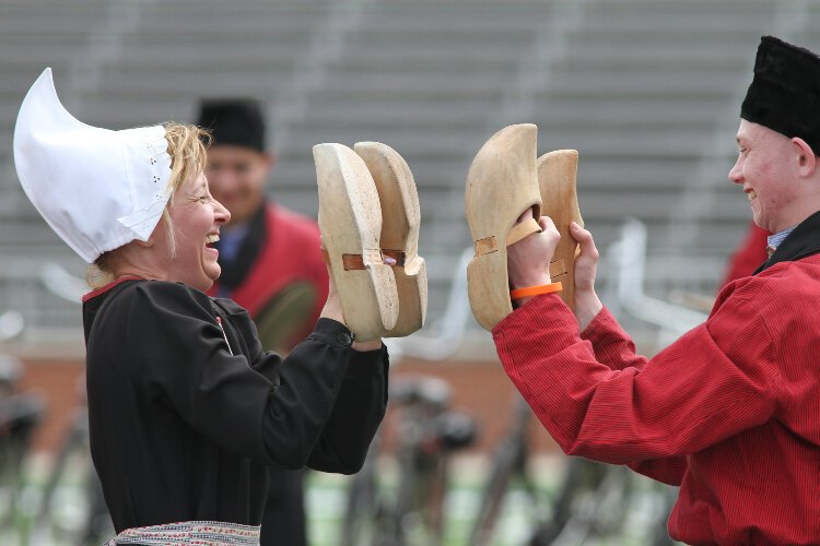 Members of Bicycle Showband Crescendo hit their wooden shoes together while performing at Hope College’s Ray and Sue Smith Stadium during their debut performance at the Tulip Time Festival, May 12.