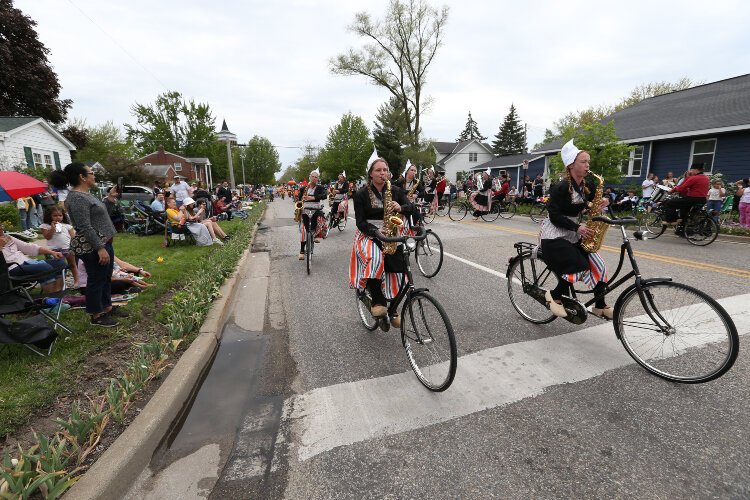 Spectators along Van Raalte Avenue look on as Bicycle Showband Crescendo performs in the Tulip Time Festival’s Volksparade, May 13. The showband was the last band to perform in this parade.