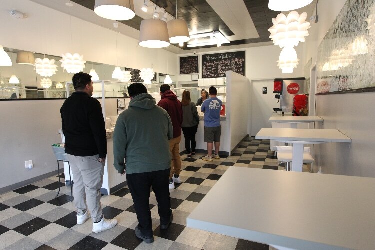 Customers wait in line to order food, prepared daily with a "lotta love" at Daddio's 2 dine-in restaurant in Holland, Michigan, March 23, 2022. (J.R. Valderas)