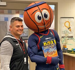 Gentex's Dan Quintanilla and Gold Mascot, Buckets, visited Roosevelt Elementary in Zeeland. (Gentex)