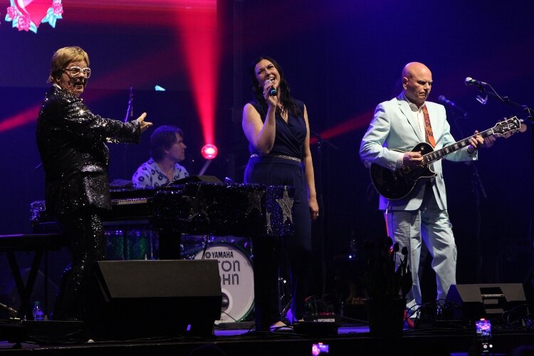 Holly DeWitt, of Hudsonville, center, sings a duet with Elton Rohn as they perform Elton John’s 1976 single “Don’t Go   Breaking My Heart” at the Holland Civic Center during the   opening night of the Tulip Time Festival, May 7.