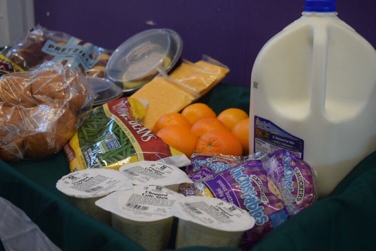 Milk, fruit and other food staples are packed into bags given to those in need. 