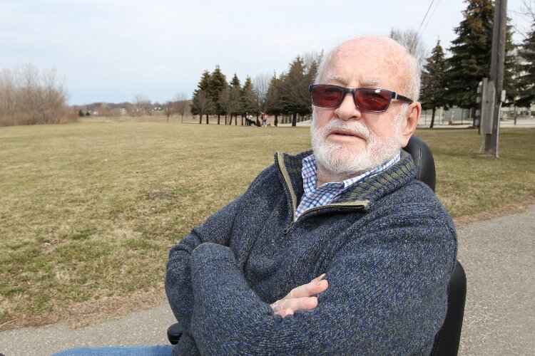 Frank Kraai, of Holland, poses along the Window on The Waterfront park in Holland, Michigan where a new ice rink will be built after he donated $1 million toward the effort.