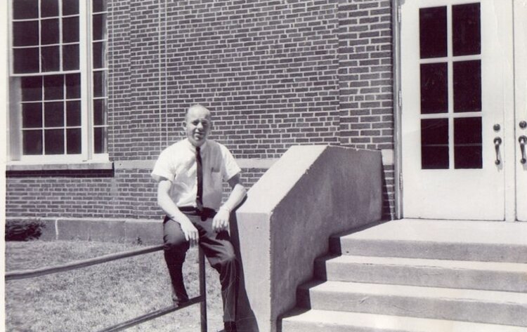 Frank Kraai, now retired as an educator, poses in front of Beechwood School in this file photo.