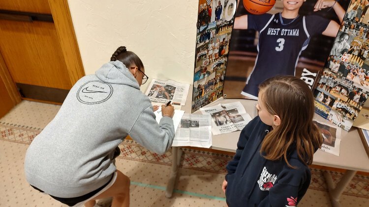 West Ottawa point guard and Miss Basketball Michigan Gabby Reynolds signs an autograph for a young fan.