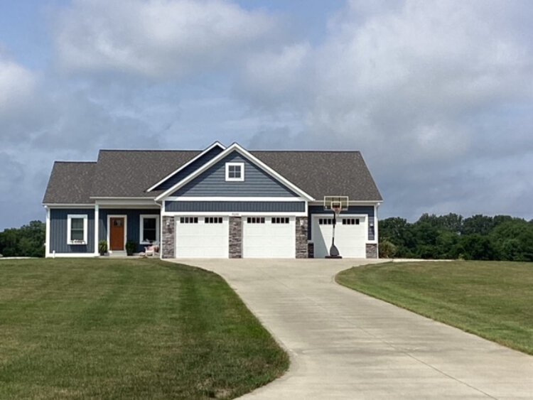 Not much question about which aspect of modern life influenced the design of this home. Garages, up front and center.