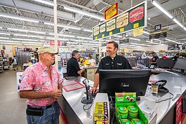 Andrew Gemmen serves a customer at his Hudsonville Ace Hardware store, named 2021 Coolest Hardware Store by the company.