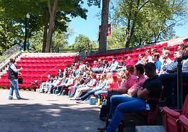 Gentex talent acquisition specialist Chris Pollack speaks to a group of the company's interns gathered at Zeeland’s Lawrence Street Park last week.