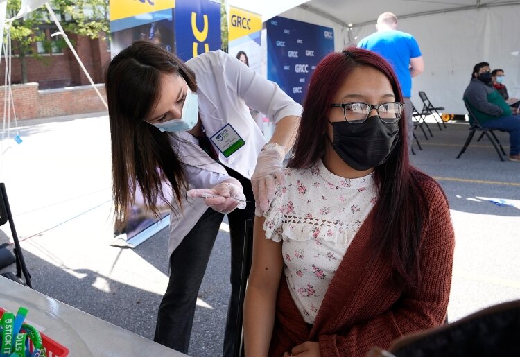 A student receives a COVID-19 vaccination at GRCC. 