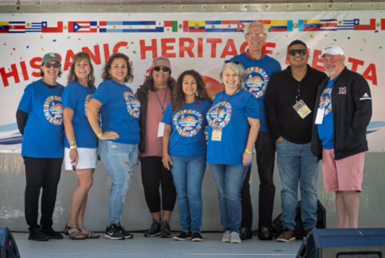 Reyna Masko with a group of volunteers at Grand Haven's Hispanic Heritage Fiesta.