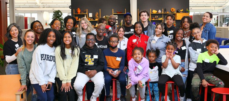 Students and leaders from I Am Academy pose with MillerKnoll employees after a day learning at the company's Design Yard.