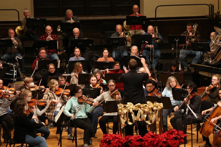 HSO Music Director and Conductor Johannes Müller Stosch rehearses the orchestra for the holiday concert. (J.R. Valderas)