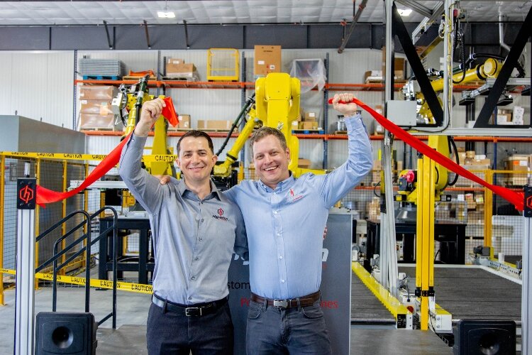 Hyperion President Jeremy Wright and VP Troy Mohrland, (on left) celebrate at the company's ribbon-cutting ceremony. 