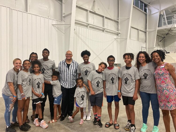 I Am Academy students and their parents gather for a photo with Byron Stripling after the concert. 