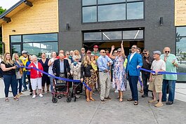 Mark Powers cuts the blue ribbon to officially open Tanglefoot Park with the support of Village board members. (Brittany Meyers)