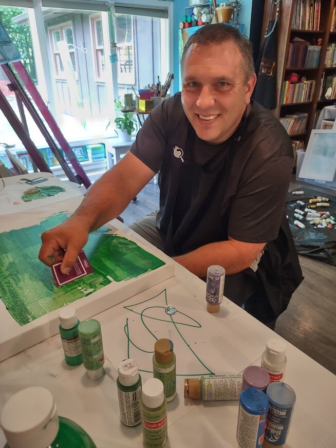 Travis Williams works on his painting. 