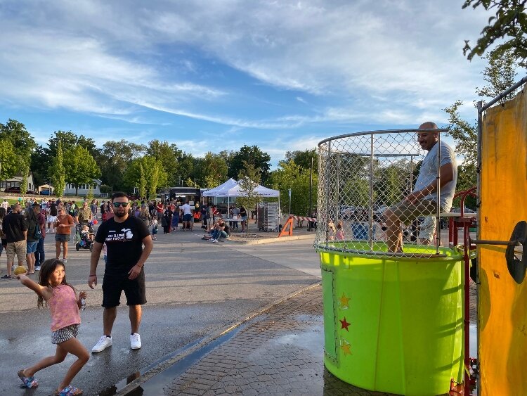 Gentex employees volunteered to sit in the dunk tank during the Gentex Block Party. (Shandra Martinez)