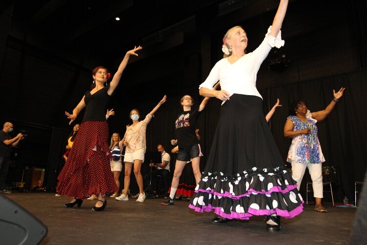 Michelle Millman and Laura Alionte, dancers of Companeros de Flamenco from Farmington Hills, Michigan, teach members of the audience how to dance the "rumba" on stage of the Holland Civic Center during the International Festival of Holland, August 21