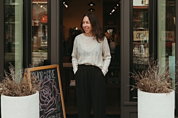 Jenny Van Veen, owner of Frances Jaye in downtown Holland, poses in front of her store.