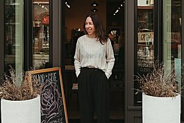 Jenny Van Veen, owner of Frances Jaye in downtown Holland, poses in front of her store.