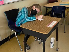 Karissa Moelker, 10, a fifth grade student at Allendale Christian School writes a letter of kindness to a community leader.