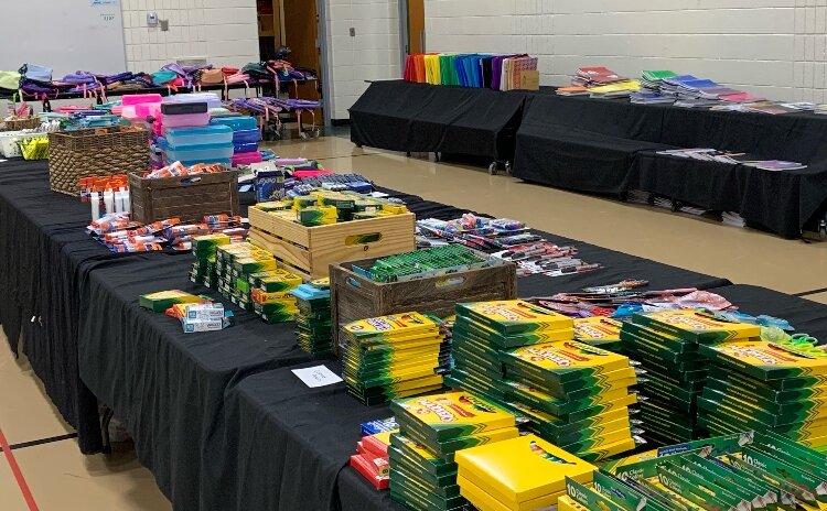 The drive collects new backpacks and supplies at local churches, businesses, and Love Your Neighbor, inviting public donations.