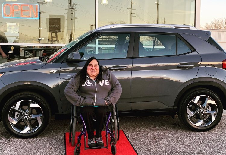 Lucia Rios in front of her 2021 Hyundai Venue.