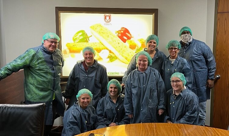 Cultural Immersion Experiences Across the Bridge participants pose for a photo at Cole’s Bakery.