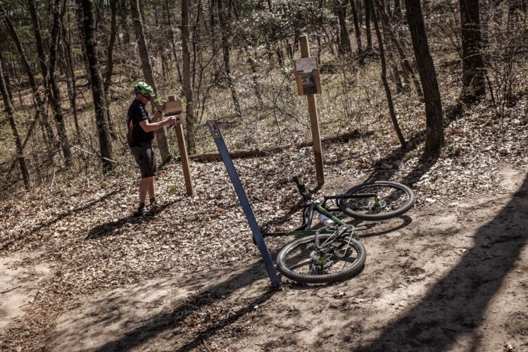 Mosquito Trails volunteer Mark Stoll checks a tool box to make sure it is properly stocked. The trail is dotted with community tool boxes for riders in case of punctures and other issues. The boxes were created and stock by volunteers.