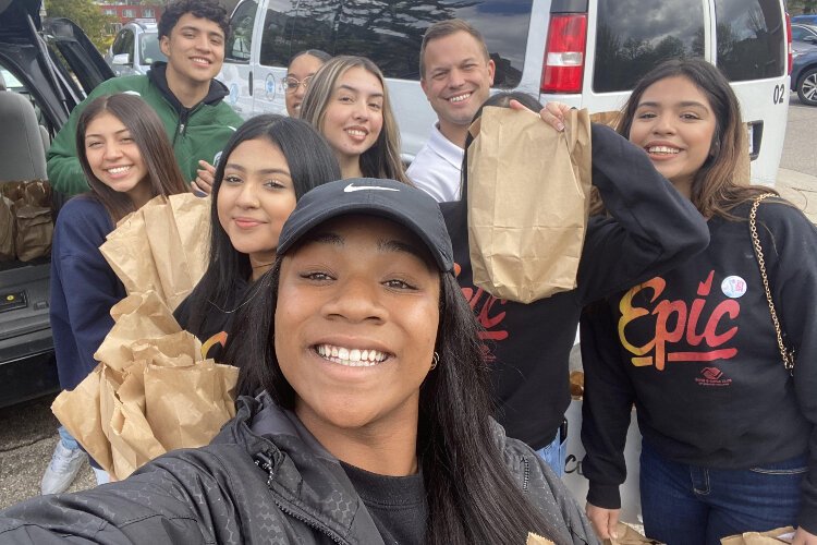 Dulce Salazar (right) organized donations for care packages and her peers to deliver them to the Michigan State University campus recently.