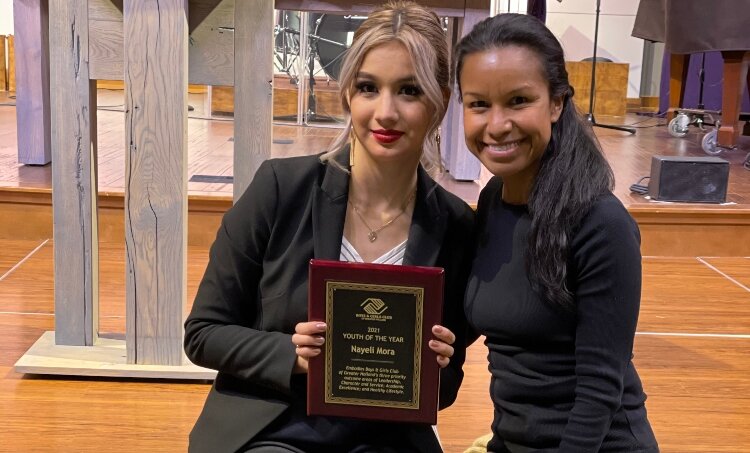 Nayeli Mora shows off her Youth of the Year award with Cynthia Martinez.