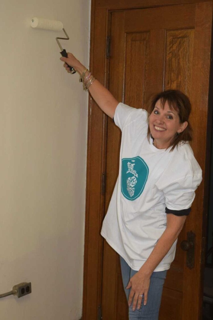 MC4T Founder Patty Janes paints during a volunteer project.