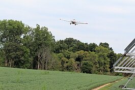 Crop dusting planes maneuver to avoid electric lines, irrigation towers, woods and more when working. (Photo by Bev Berens) 