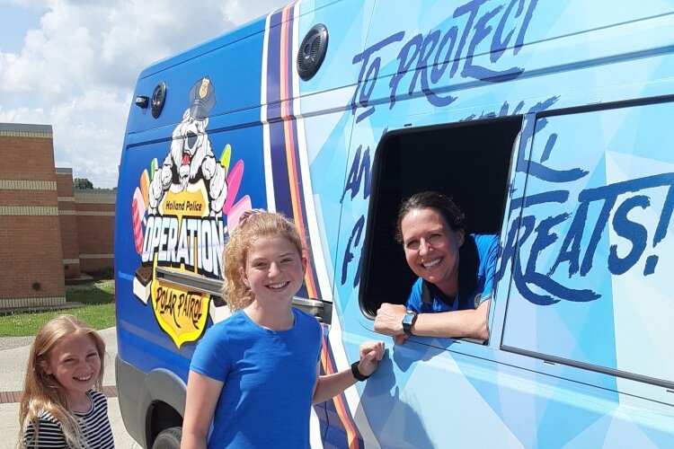 Holland's four community policing officers is each assigned to one quadrant of the city, but all get to help serve frozen treats from the Polar Patrol vehicle each summer.