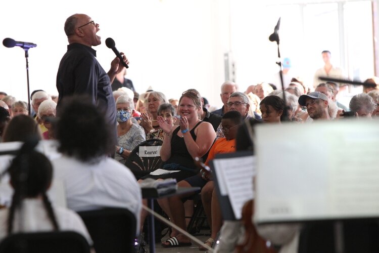 Members of the audience react to Byron Stripling's performance with the Holland Symphony Orchestra while attending the "Pops at the Pier" concert at Eldean Shipyard in Macatawa, Michigan, June 16, 2022.  
