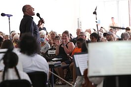 Members of the audience react to Byron Stripling's performance with the Holland Symphony Orchestra while attending the "Pops at the Pier" concert at Eldean Shipyard in Macatawa, Michigan, June 16, 2022.  