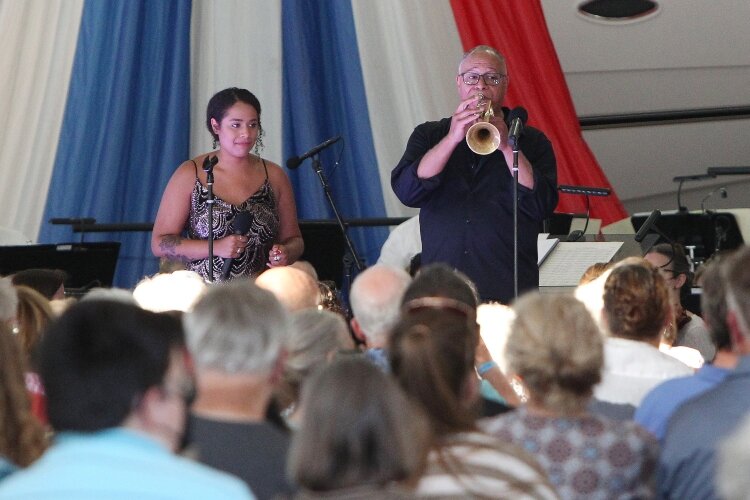 Byron Stripling, on trumpet, and Sydney McSweeney perform with the Holland Symphony Orchestra during their "Pops at the Pier" concert at Eldean Shipyard in Macatawa, Michigan, June 16, 2022.