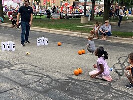 Kids who attended Pumpkinfest enjoyed having their faces painted, climbing on inflatables, riding a barrel train, and playing a variety of fall yard games, including bowling with pumpkins.